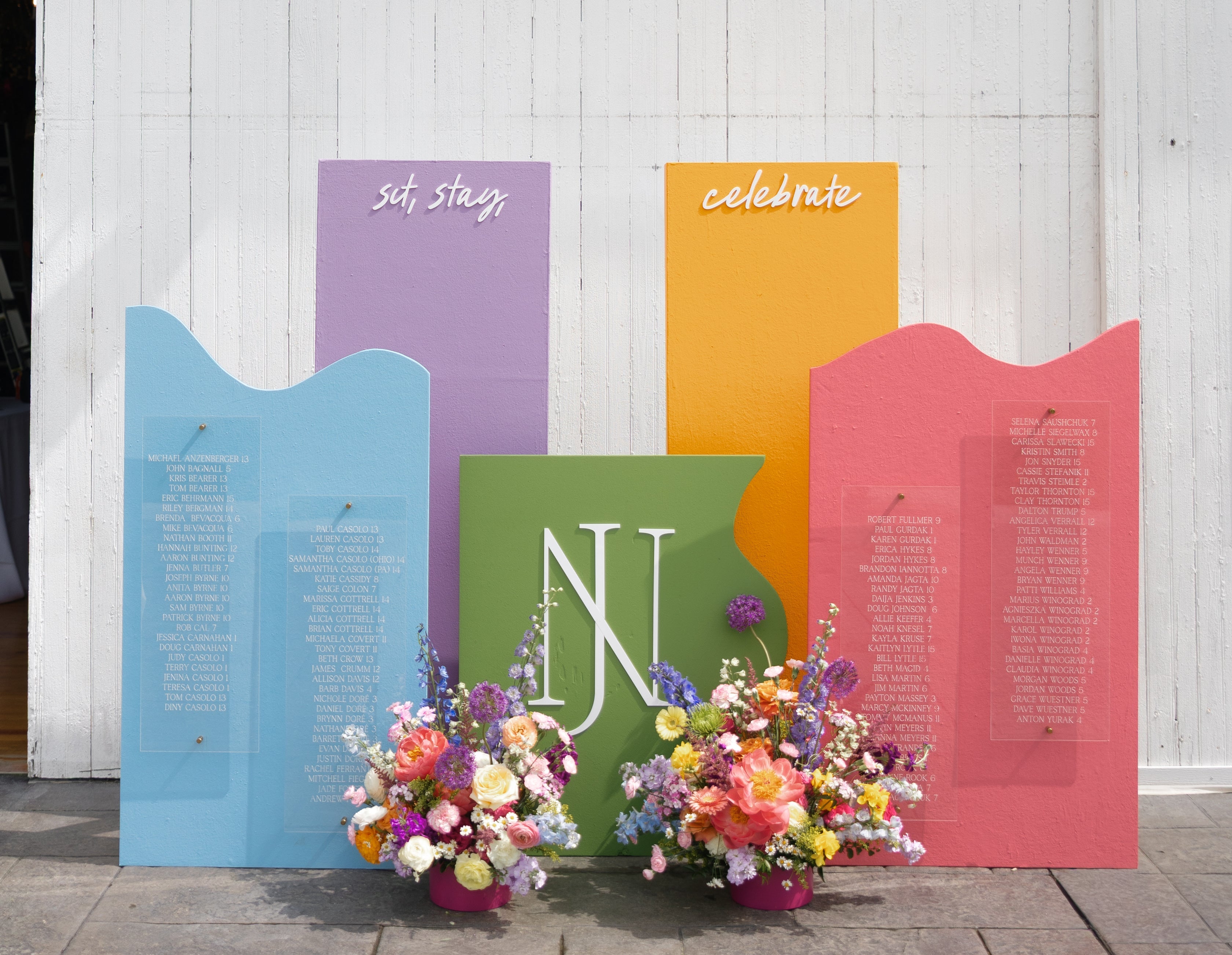 Colorful acrylic boards used to display names for a wedding seating chart.