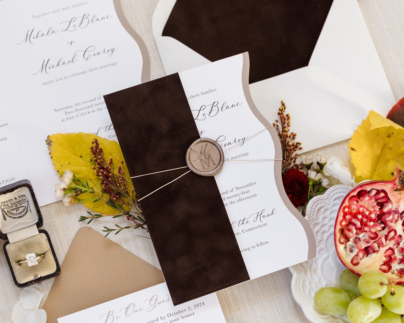 Flat lay of a wedding invitation suite that features rich, brown velvet on the envelope liner and the invite sleeve.