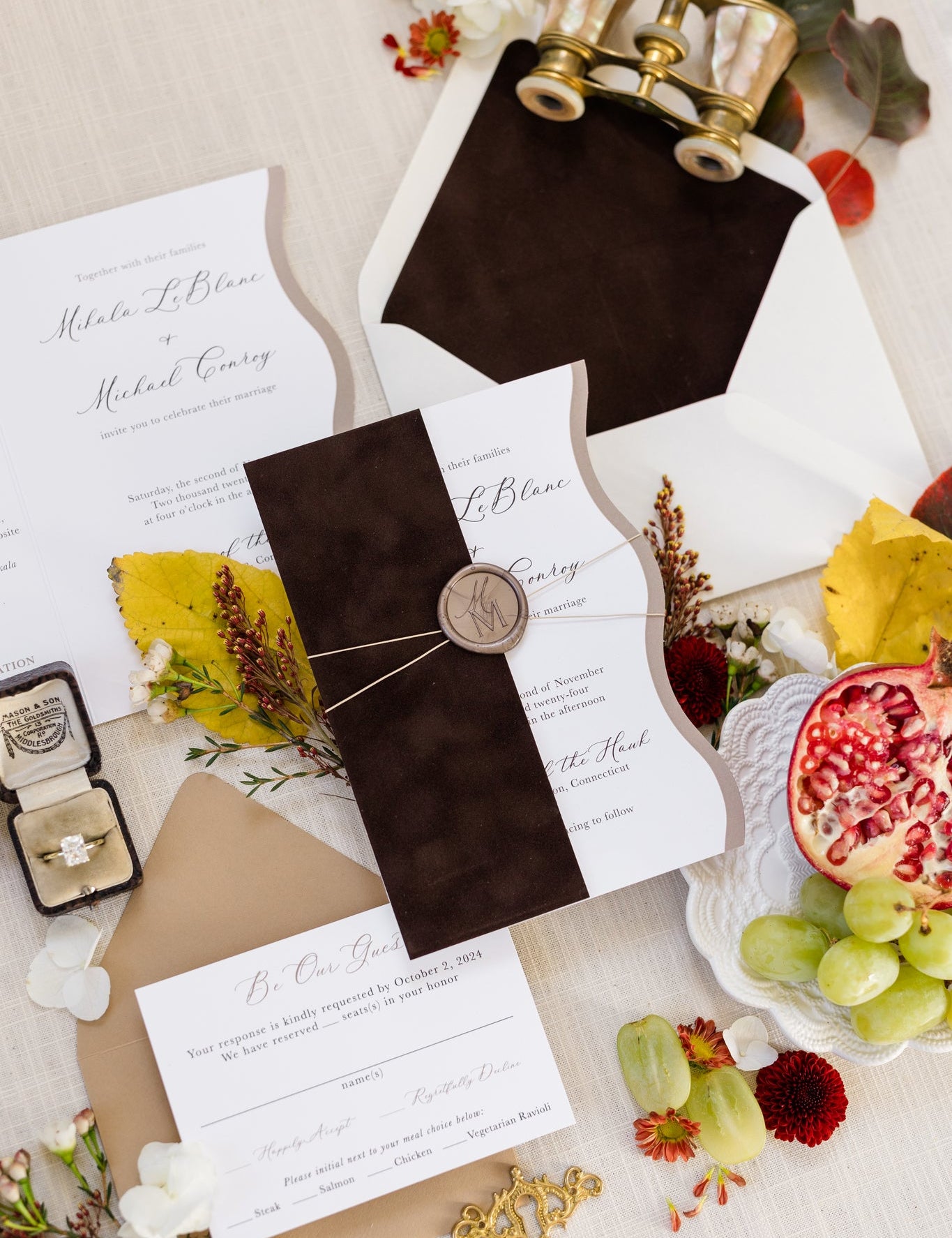 Flat lay of a wedding invitation suite that features rich, brown velvet on the envelope liner and the invite sleeve.