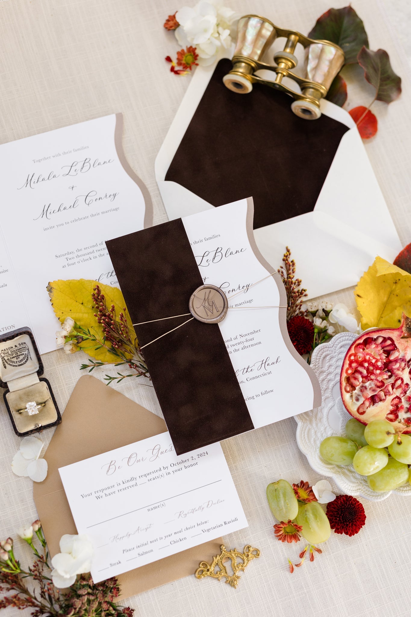 Flat lay of a wedding invitation suite that features rich, brown velvet on the envelope liner and the invite sleeve.