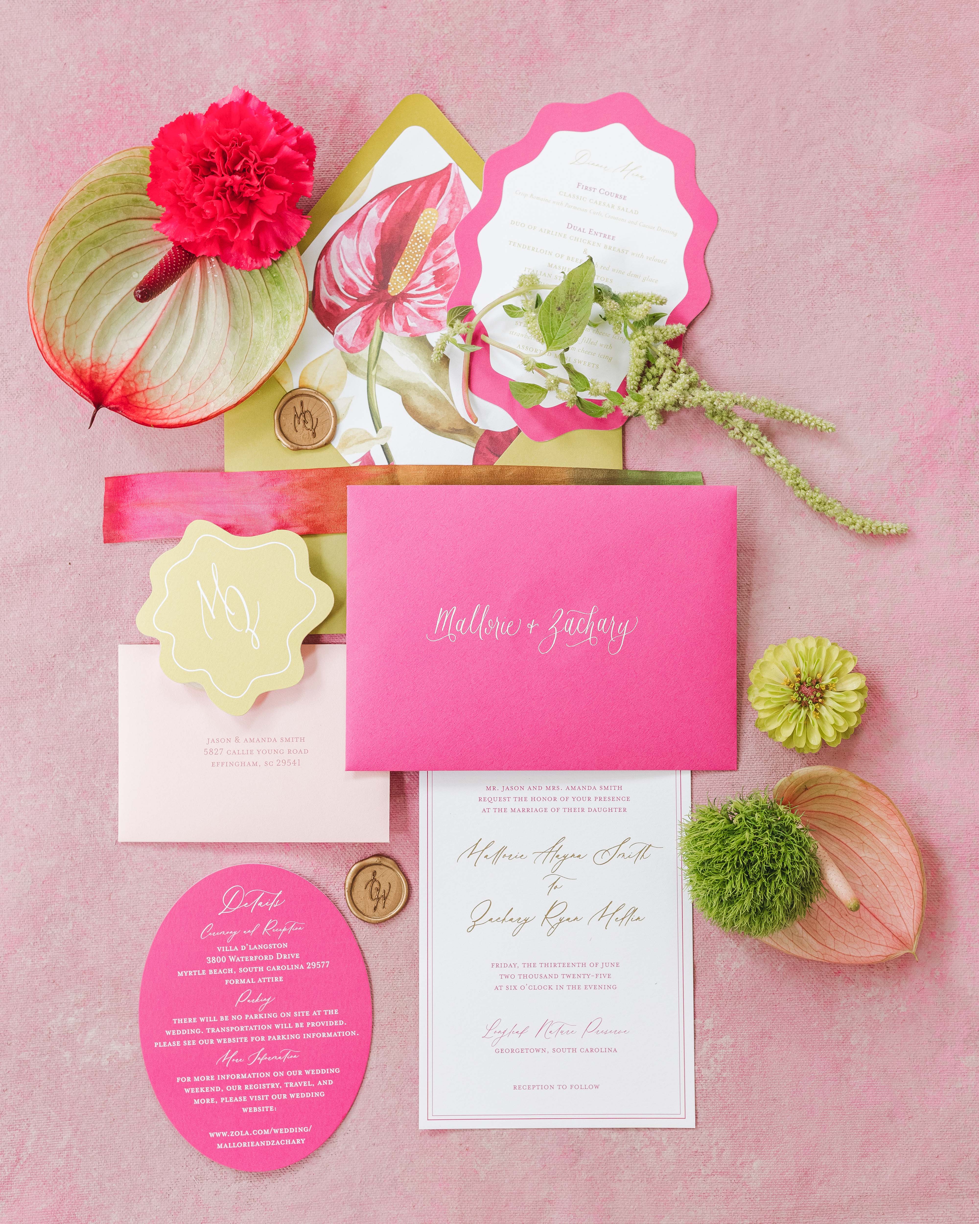 Colorful wedding invitation set with floral elements on a pink background