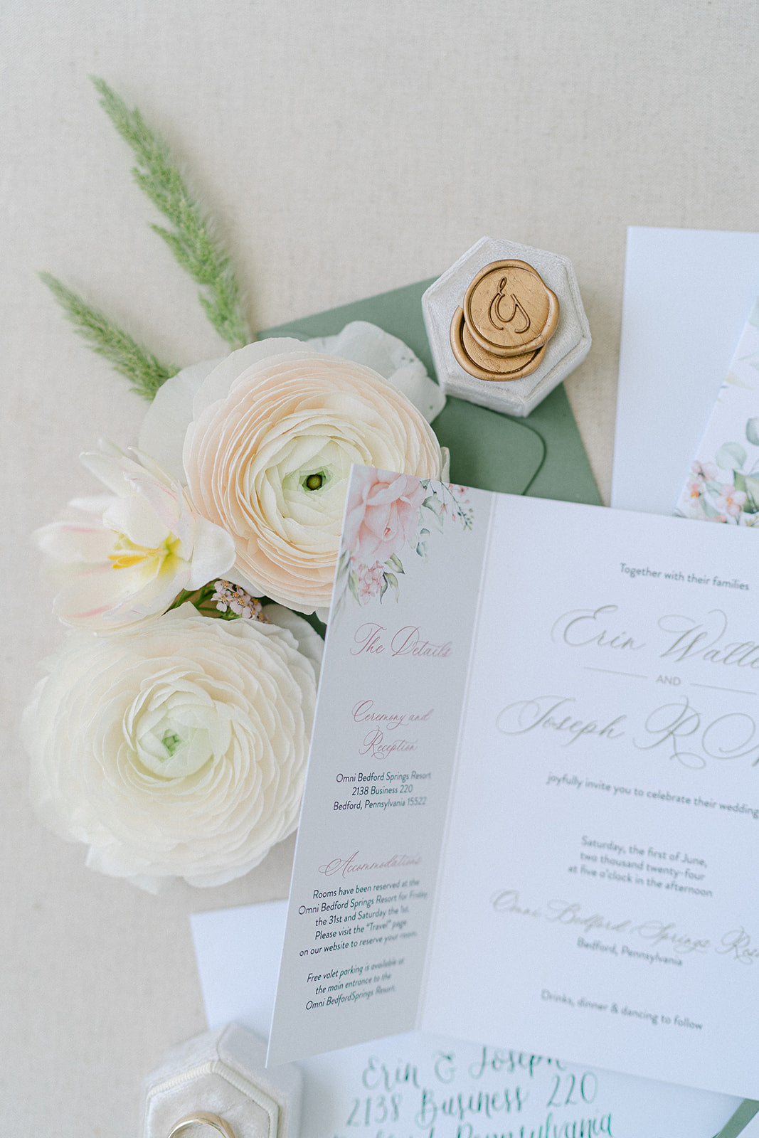 wedding cards with gold wax seals and white flowers