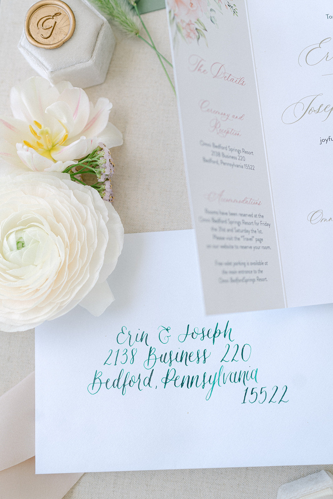 green handwritten calligraphy on white envelope