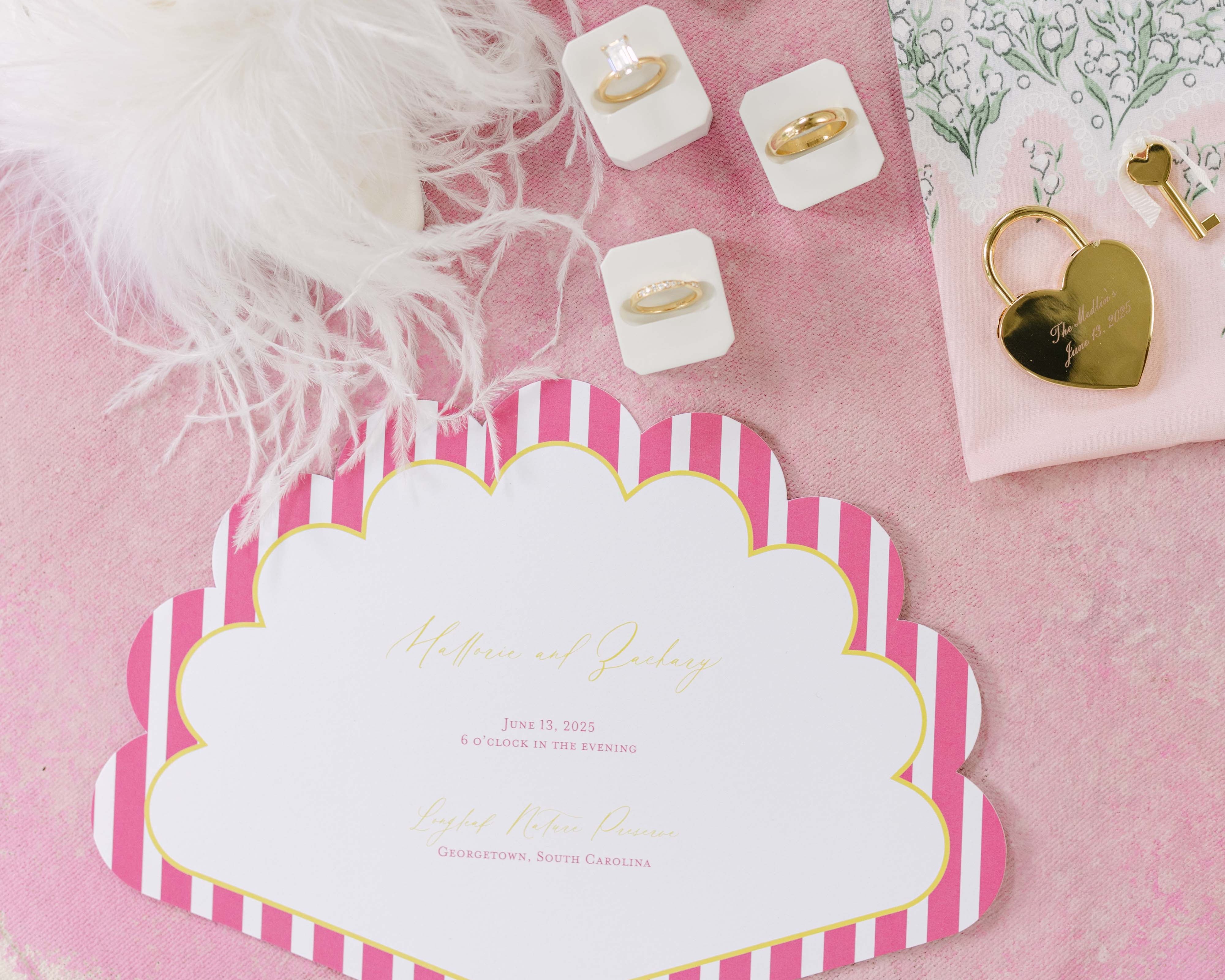 Bridal accessories including a card, jewelry, and decorative elements on a pink background