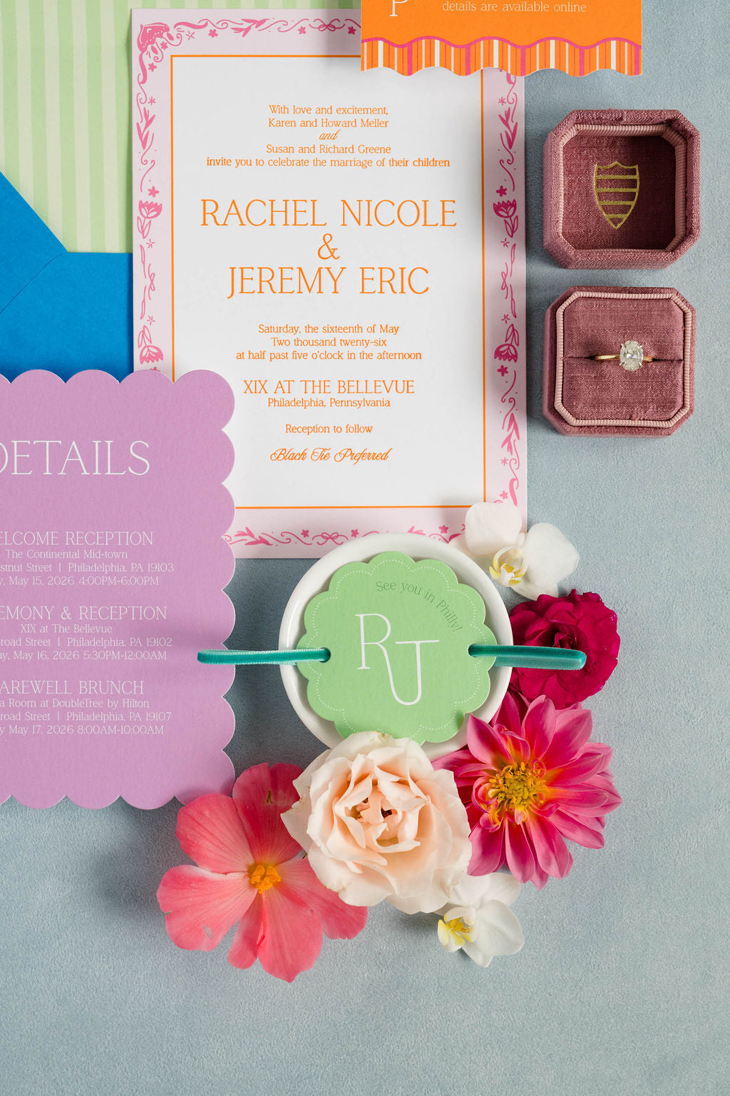 Wedding invitation with flowers and ring box on a gray background