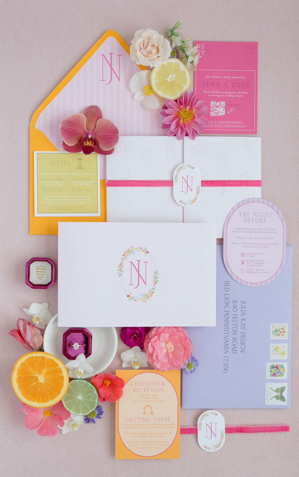 Colorful stationery set with floral elements on a pink background