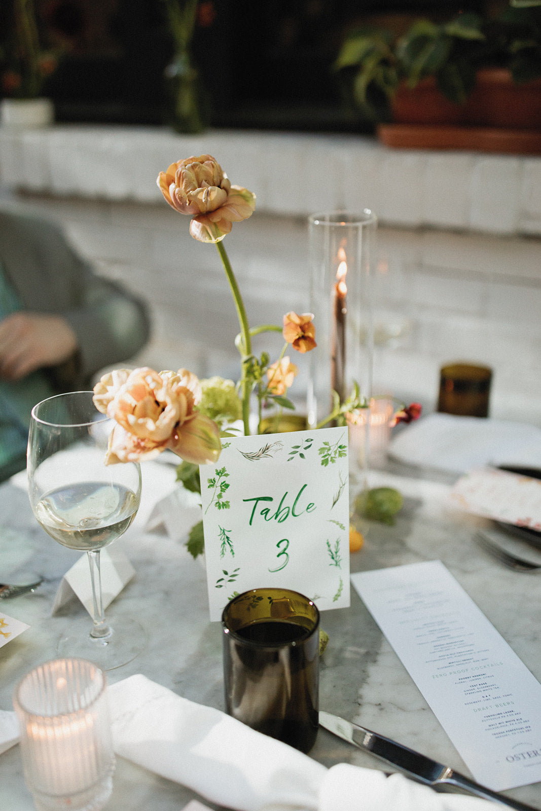 wedding table number with green script font and hand painted greenery 
